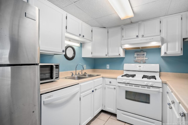 kitchen with light tile patterned floors, sink, white cabinetry, and appliances with stainless steel finishes