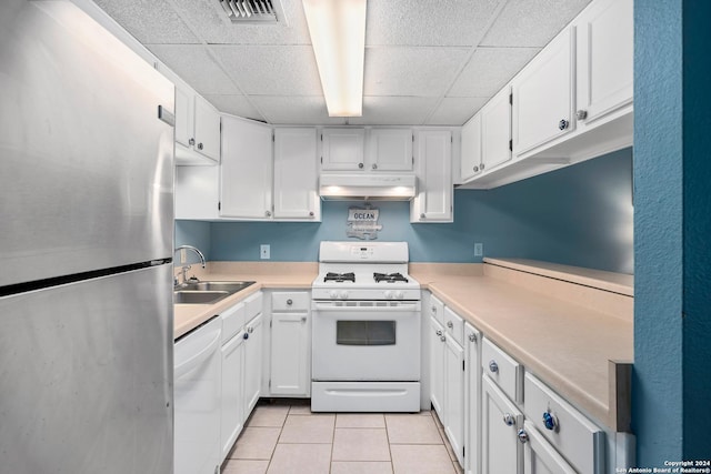 kitchen featuring sink, white cabinetry, white appliances, and light tile patterned floors