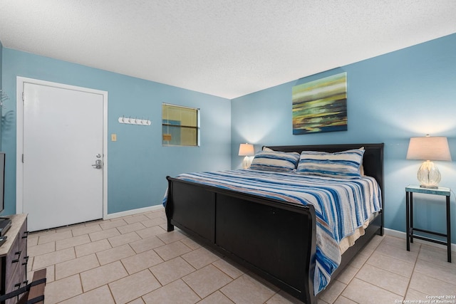 tiled bedroom with a textured ceiling