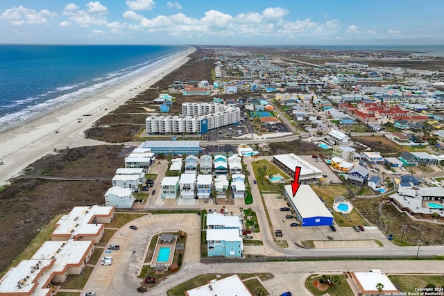 drone / aerial view featuring a water view and a view of the beach