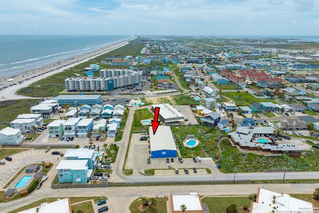 bird's eye view featuring a water view and a view of the beach