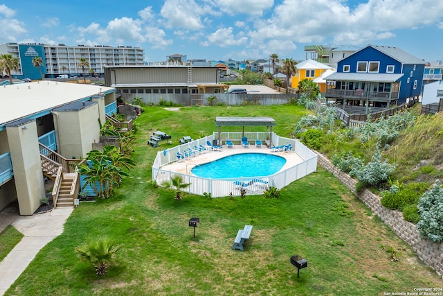 view of pool featuring a lawn and a patio