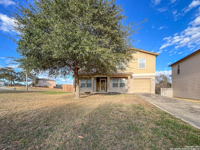 view of front of home featuring a garage and a front lawn