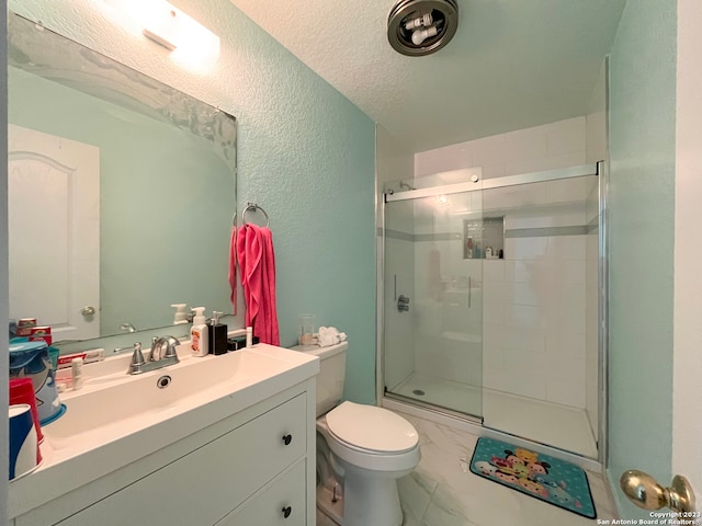 bathroom with a shower with shower door, a textured ceiling, tile patterned floors, toilet, and vanity