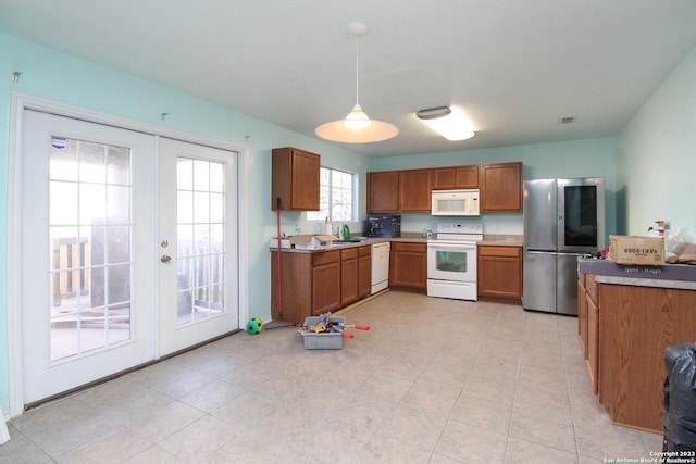 kitchen with french doors, white appliances, decorative light fixtures, and light tile patterned floors