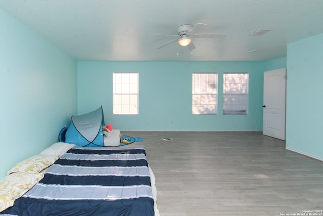 bedroom featuring hardwood / wood-style flooring and ceiling fan