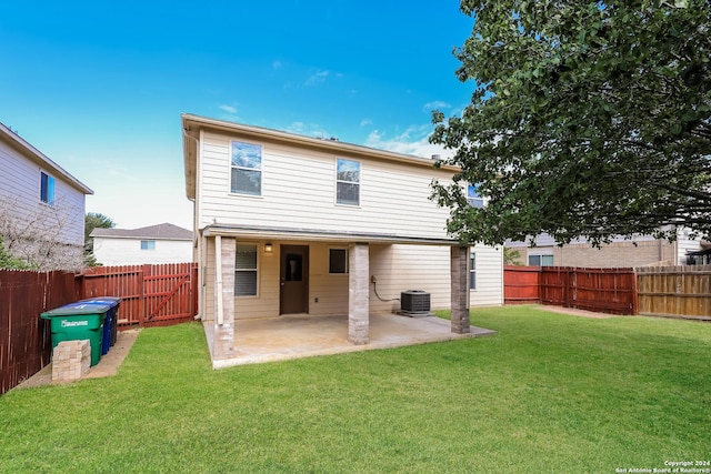 back of property featuring a patio, central air condition unit, and a lawn