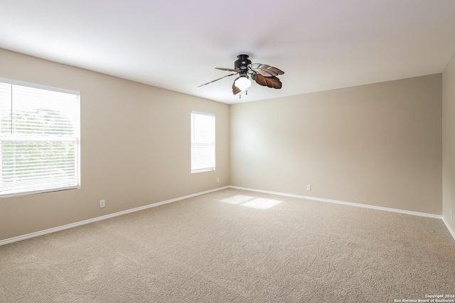 empty room with carpet floors and ceiling fan