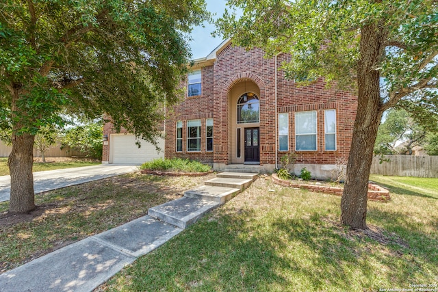 view of front of property featuring a garage and a front yard