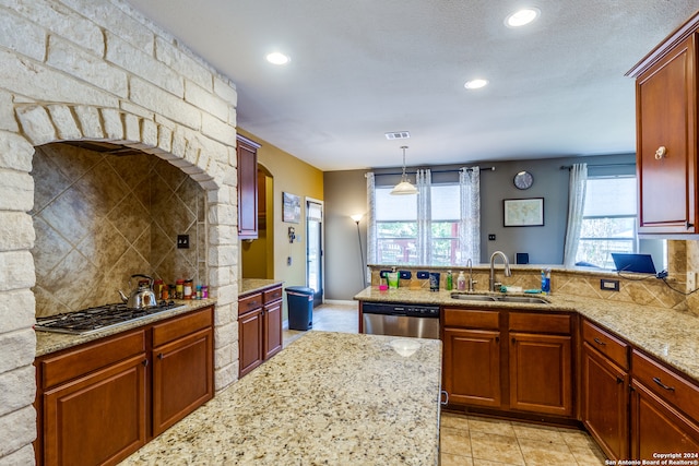 kitchen with sink, pendant lighting, light stone counters, decorative backsplash, and light tile patterned flooring