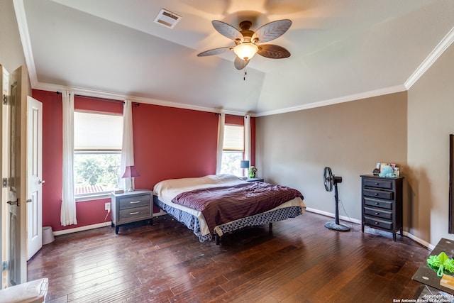 bedroom with vaulted ceiling, ceiling fan, crown molding, and dark wood-type flooring