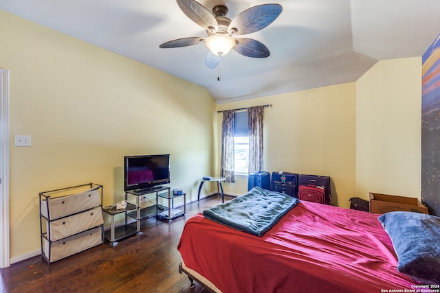 bedroom featuring dark hardwood / wood-style floors, vaulted ceiling, and ceiling fan