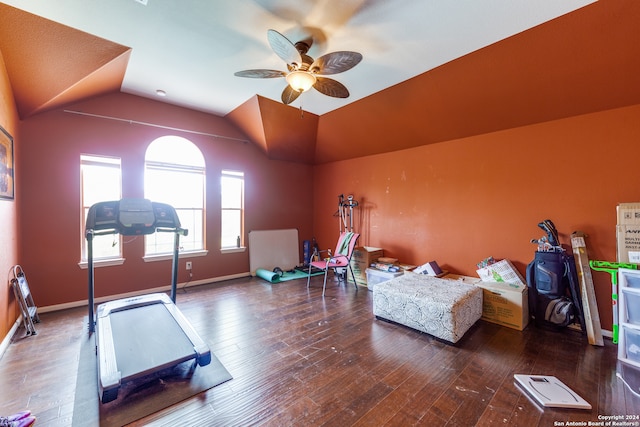 workout area with ceiling fan, lofted ceiling, and dark wood-type flooring