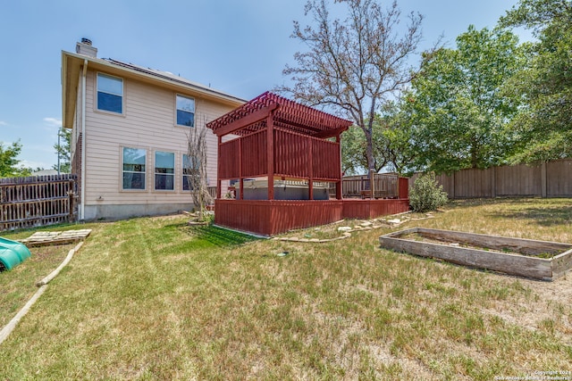 rear view of house featuring a yard and a deck