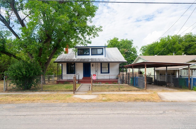 view of front facade with covered porch and a carport