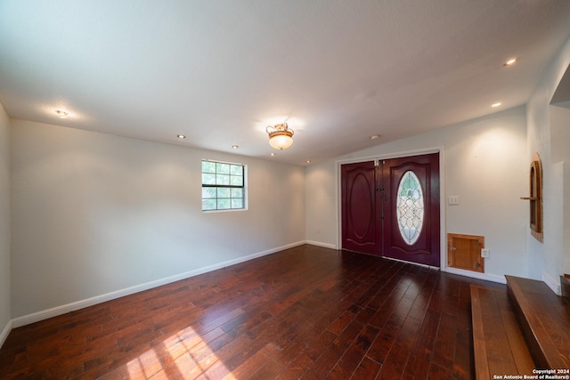 foyer with vaulted ceiling and wood-type flooring