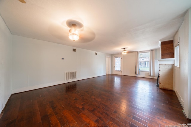 unfurnished living room with dark wood-type flooring