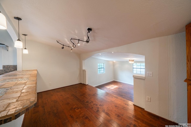 additional living space with dark hardwood / wood-style flooring