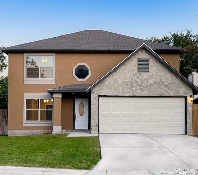 view of front of home featuring a garage and a front yard