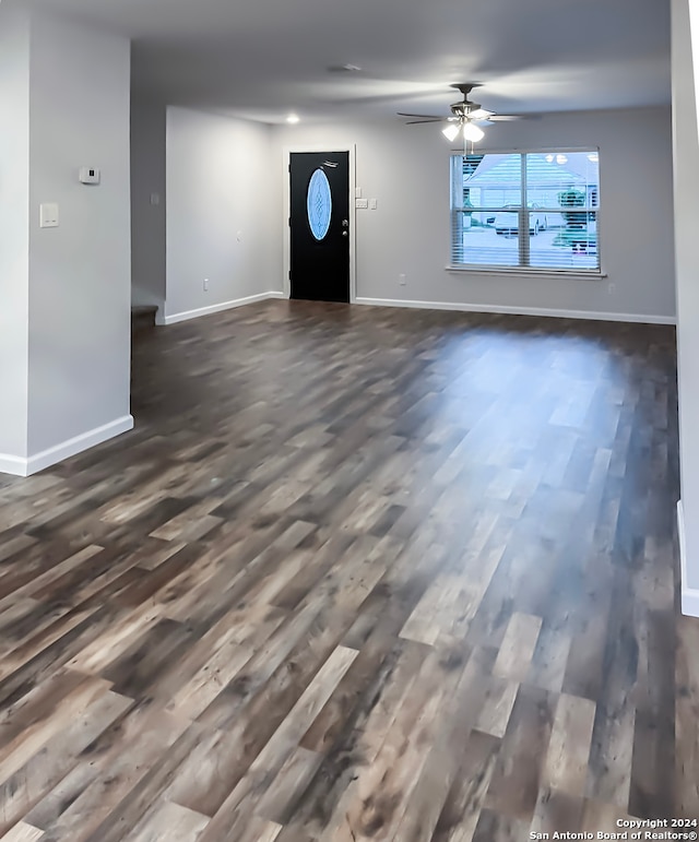 interior space with dark wood-type flooring and ceiling fan