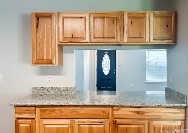 kitchen featuring light stone counters