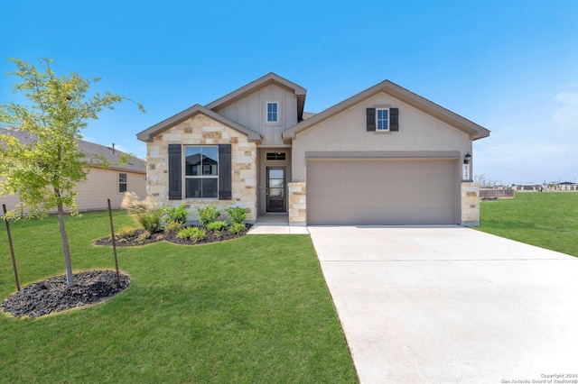 craftsman inspired home with a garage and a front lawn