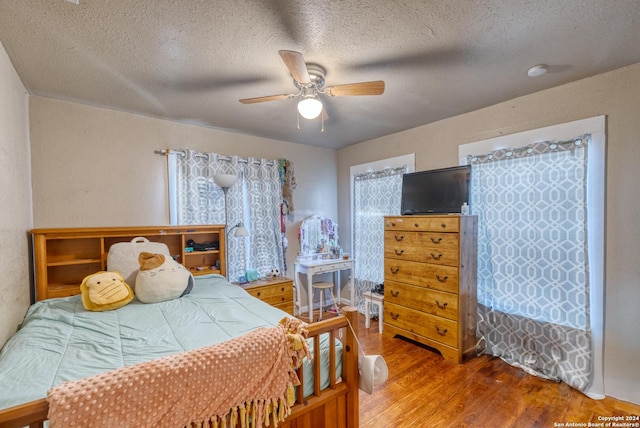 bedroom featuring a textured ceiling, hardwood / wood-style flooring, and ceiling fan