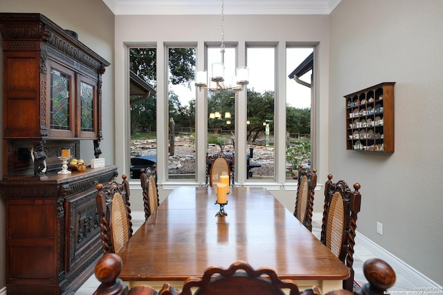 dining space with ornamental molding and a notable chandelier