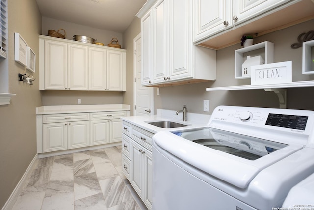 washroom with cabinets, sink, and washer / clothes dryer