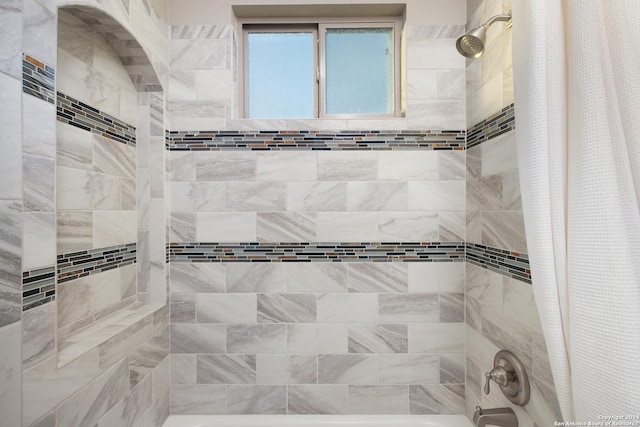 bathroom with shower / bath combo with shower curtain