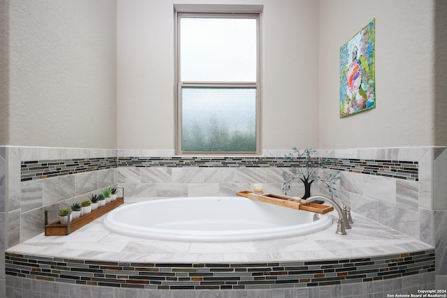 bathroom with tiled bath