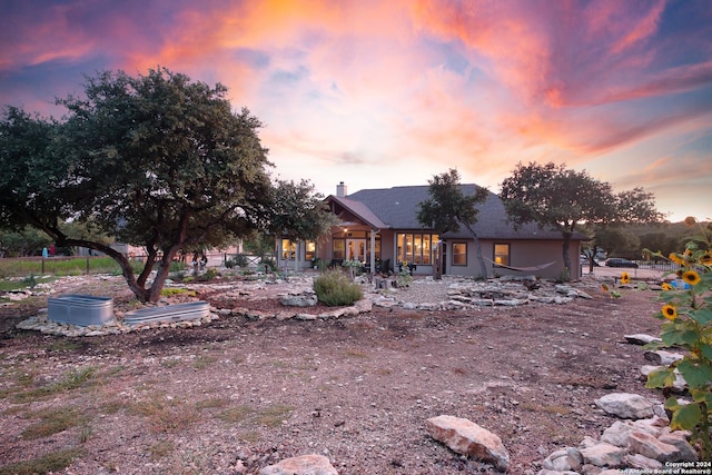 view of back house at dusk