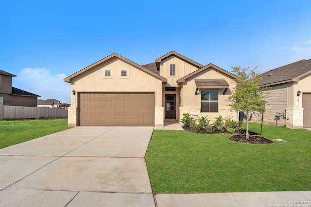 view of front of home with a garage and a front lawn