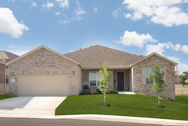 view of front of property featuring a garage and a front lawn