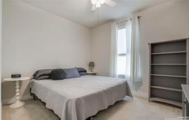 bedroom featuring ceiling fan and light colored carpet