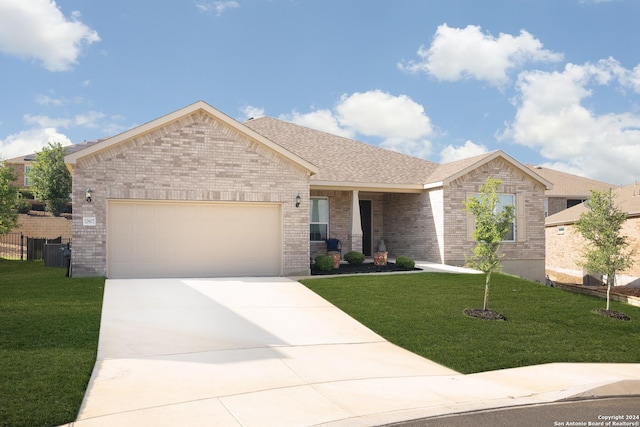 view of front of home with a garage and a front lawn