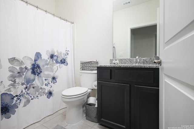 bathroom with tile patterned floors, vanity, and toilet