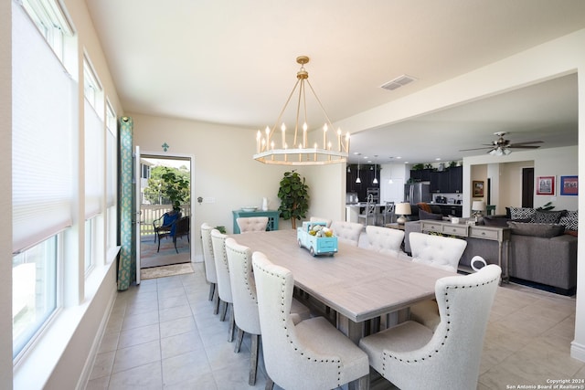 dining area with ceiling fan with notable chandelier and light tile patterned floors