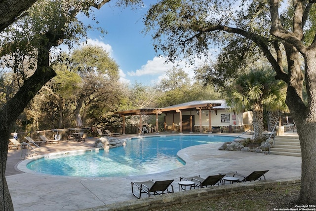 view of swimming pool with a patio area