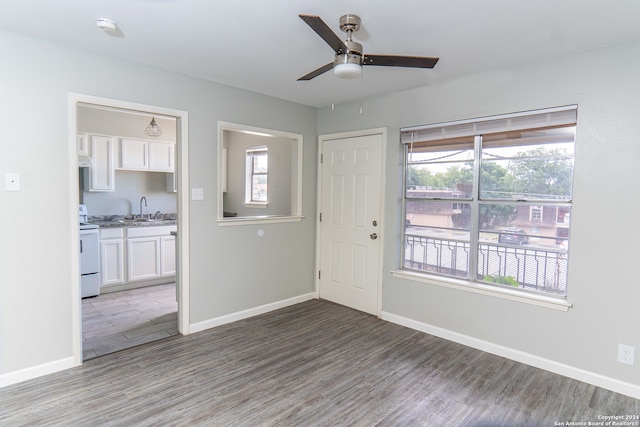 interior space with dark wood-type flooring, sink, plenty of natural light, and ceiling fan