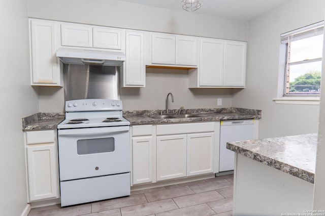 kitchen with white cabinets, sink, and white appliances