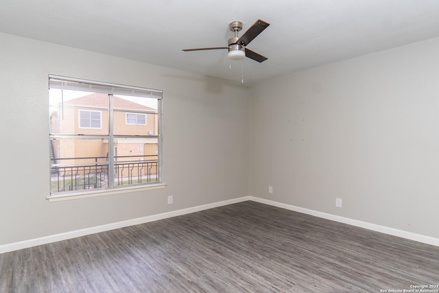 empty room with dark wood-type flooring, ceiling fan, and plenty of natural light