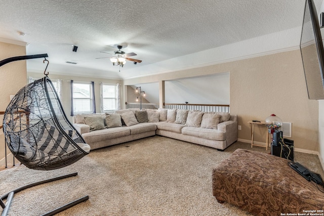 carpeted living room featuring ceiling fan, a textured ceiling, and crown molding