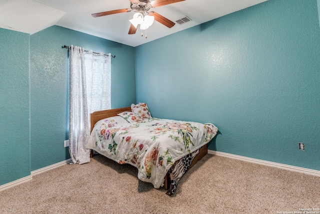 carpeted bedroom with vaulted ceiling and ceiling fan