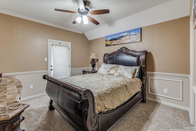 carpeted bedroom featuring ceiling fan, crown molding, and lofted ceiling