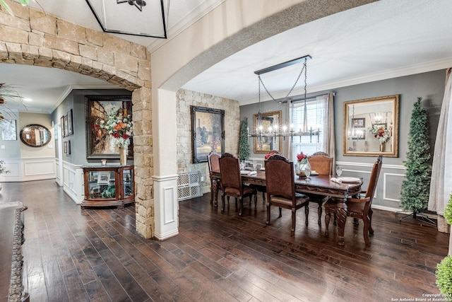 dining area featuring dark wood-type flooring, a textured ceiling, and ornamental molding