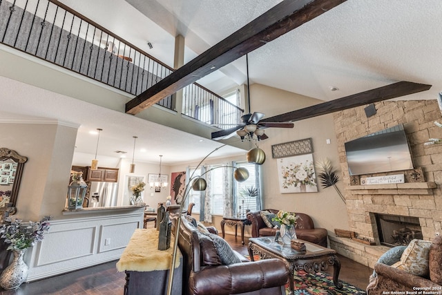 living room featuring a textured ceiling, ceiling fan, dark hardwood / wood-style flooring, and a fireplace