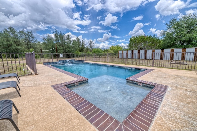 view of swimming pool featuring pool water feature and a patio