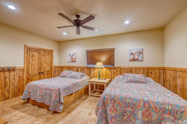 bedroom featuring ceiling fan and a textured ceiling