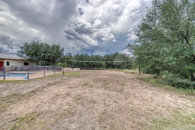 view of home's community with volleyball court and a swimming pool